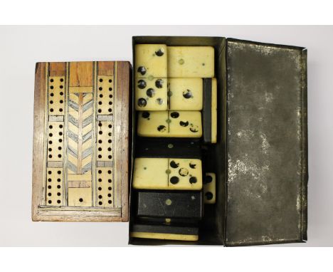 A set of 28 vintage bone dominoes, together with a folding cribbage board with one peg