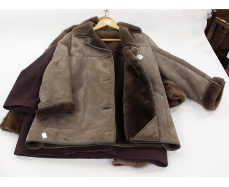 A 3/4 aubergine coloured cashmere coat with a amethyst coloured brooch with a pearl edging, together with a lovatt green genu