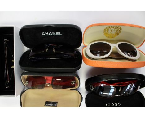 A collection of designer style sunglasses to include two pairs of Chanel, rimless and a pair of Ed Hardy rimless, heavily emb