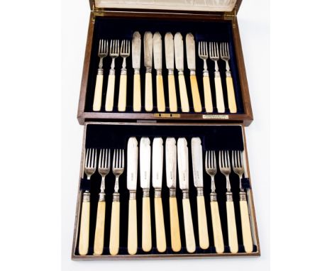 A set of twelve George V silver fish knives and forks, with reeded collars and bone handles, in fitted oak case, Harrison Bro