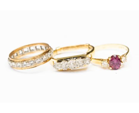 A ruby and diamond ring, oval ruby to the centre with diamonds either side, size P, a five stone diamond ring, in 18ct gold, 