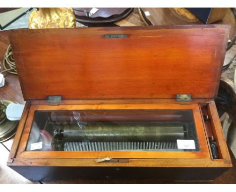 A 19th century musical box with ebonised case and interior cylinder playing one out