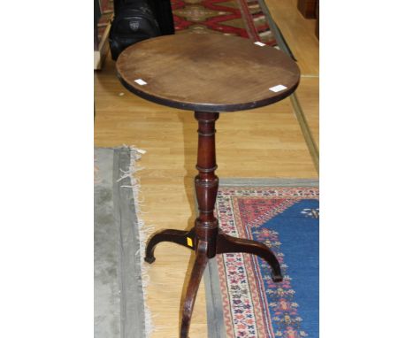 A George III mahogany tripod table, the top raised on a turned column and standing on downswept legs, 70cm high