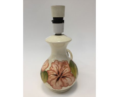 A Moorcroft Hibiscus table lamp, baluster form, cream with peach flowers 