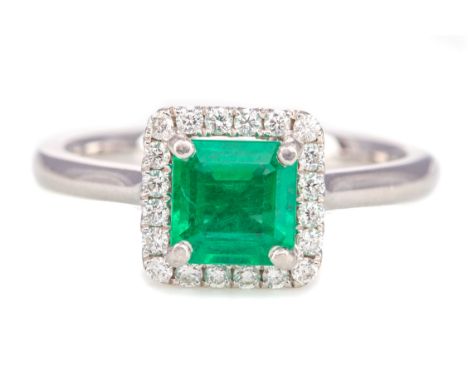 EMERALD AND DIAMOND RING, set with a step cut emerald of approximately 1.00 carat, within a halo of round brilliant cut diamo