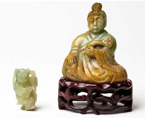 A CHINESE JADEITE FIGURE OF AN IMMORTAL, EARLY 20TH CENTURY The seated figure clad in flowing robes, his hair tied into a top