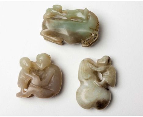 A CHINESE CELADON JADE 'MONKEY' GROUP, QING DYNASTY, LATE 19TH CENTURY The seated monkey holding her infant, the pale celadon