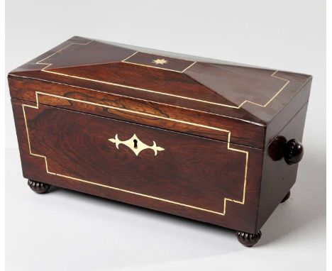 A REGENCY ROSEWOOD AND BRASS INLAID TEA CADDY The hinged sarcophagus-shaped cover enclosing three tin-lined compartments and 