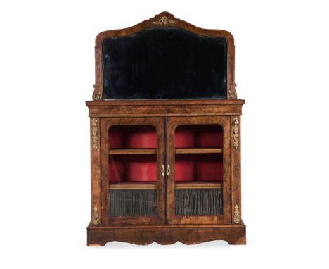 A FRENCH WALNUT AND BRASS-MOUNTED MIRROR-BACKED CHIFFONIER, 19TH CENTURY The rectangular moulded top surmounted by a shaped g