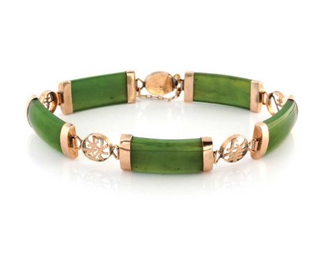 A JADE BRACELET Designed as a series of curved jade panels alternating with circular links pierced with various Chinese scrip