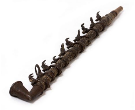 AN ANTIQUE WEST AFRICAN BRONZE AND SNAKE SKIN TRIBAL PIPE mounted with horned beasts, 51cm long