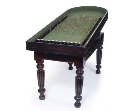 A WILLIAM IV ROSEWOOD BAGATELLE TABLE the removable lid opening to reveal a green baize with brass pegs and inset mother of p