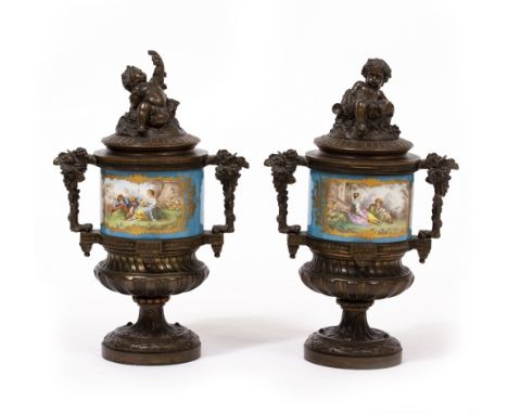 A PAIR OF 19TH CENTURY BRONZE VASES AND COVERS with blue ground Sevres style porcelain mounts each depicting a girl and a boy