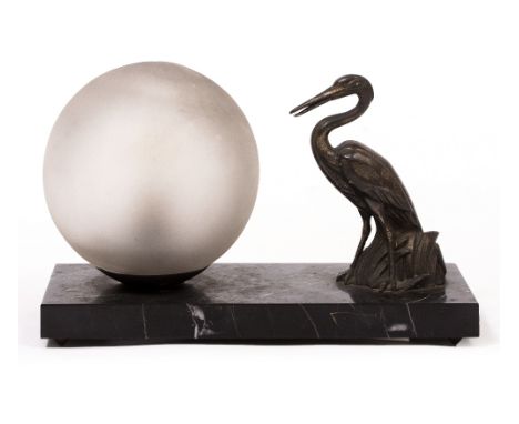 AN ART DECO TABLE LAMP with a spelter sculpture of a heron and a glass globe mounted on a rectangular marble plinth base, 24c