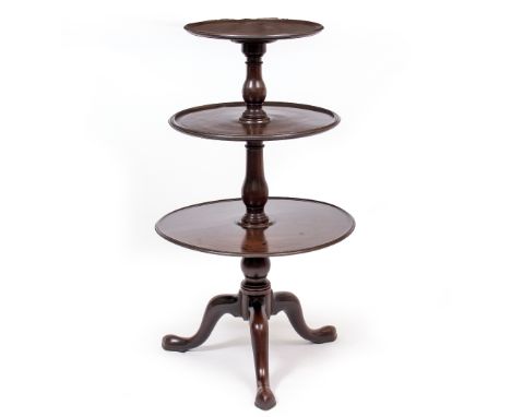 A GEORGE III MAHOGANY THREE TIER WHATNOT with dished tiers, baluster turned supports and tripod base, 60cm diameter x 106cm h