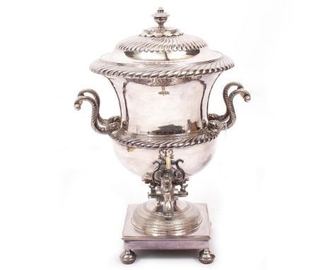 A REGENCY SILVER PLATED SAMOVAR  of classical urn form with scrolling dolphin handles, standing on square base and with ring 