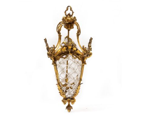 A GILT METAL LANTERN  with ribbon tie decoration, acanthus flower finial and lattice glass bead body, 35cm wide x 80cm high