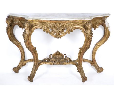 AN 18TH CENTURY FRENCH STYLE GESSO MOULDED GILT MARBLE TOPPED SERPENTINE CONSOLE TABLE decorated with masks and with shaped l