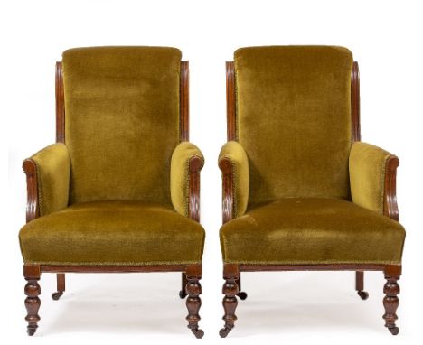 A PAIR OF LATE 19TH CENTURY WALNUT FRAMED GREEN DRAYLON UPHOLSTERED ARMCHAIRS with turned front legs and brass and ceramic ca