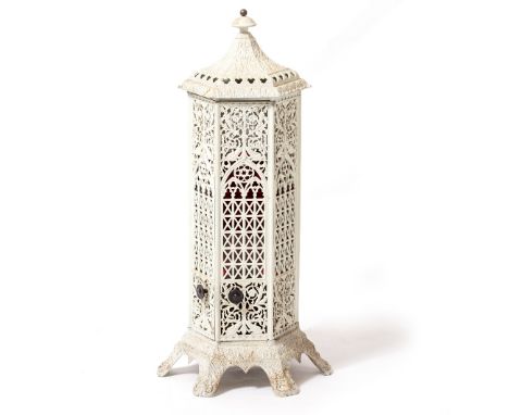 A VICTORIAN PIERCED CAST IRON CONSERVATORY HEATER of hexagonal section with gothic style decoration and spreading feet, 37cm 