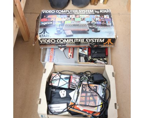 A group of Vintage gaming consoles, including Atari video computer system, Commodore User, Commodore Vic, Nintendo family com