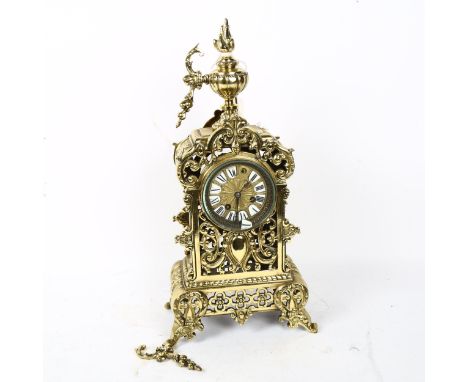 A polished cast-brass 8-day mantel clock, with hand painted white enamel numeral panels, case height 46cm, with pendulum 
