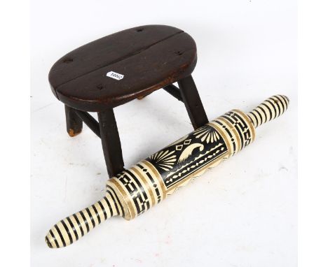 A small oak milking stool, and a Folk Art rolling pin (2) 