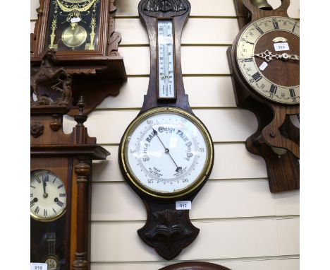 Antique aneroid barometer in carved oak case, with thermometer, height 80cm 