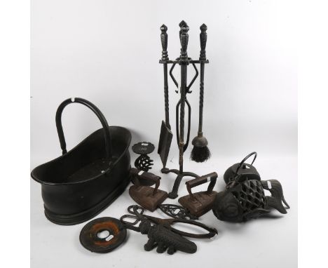 A group of wrought-iron fireside tools, flat irons etc 