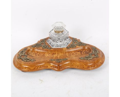 A 19th century carved shaped and polished elm deskstand, with engraved brass mounts, original hobnail glass hexagonal inkwell
