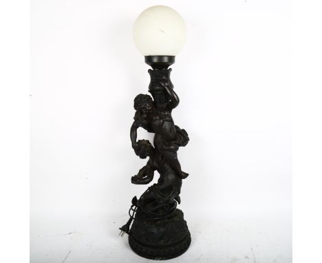A large bronzed resin figural putti table lamp, height 70cm 