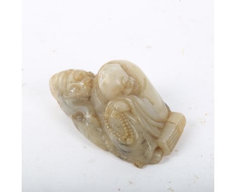 A Chinese carved and polished jade figure, sleeping sage with bead necklace and tiger, length 8.5cm 