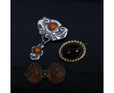 A cabochon garnet brooch stamped 14k, a double lava cameo brooch, and a Vintage Danish silver and amber pendant brooch (3) 