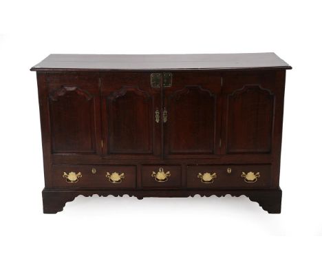 A George III Oak Mule Chest, late 18th century and adapted, the boarded top above four fielded panels, two as cupboard doors 