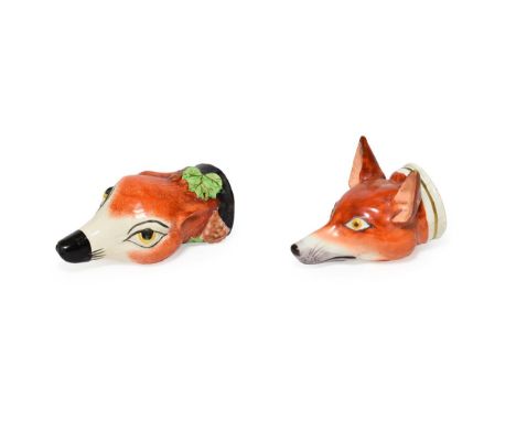 A Staffordshire Pottery Fox Mask Stirrup Cup, mid 19th century, naturalistically modelled and painted and with fruiting vine 