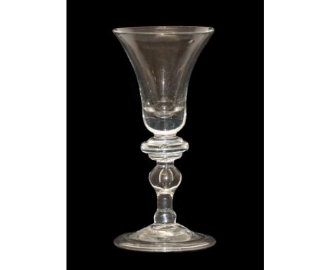 A Balustroid Wine Glass, circa 1740, the bell shaped bowl over an annular knop and stem with two further knops and air tear o