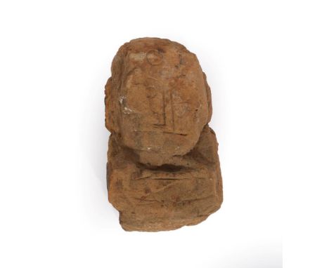 A Carved Sandstone Head, possibly Celtic, of stylised form, 43cm high.  Extensively weathered and worn. Some losses.