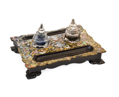 A Victorian Papier Mache Desk Standish, of ogee rectangular form with two hexagonal ink bottles and stoppers flanked by pen t