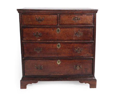 A George II Oak and Crossbanded Straight Front Chest of Drawers, 2nd quarter 18th century, the moulded top above two short an