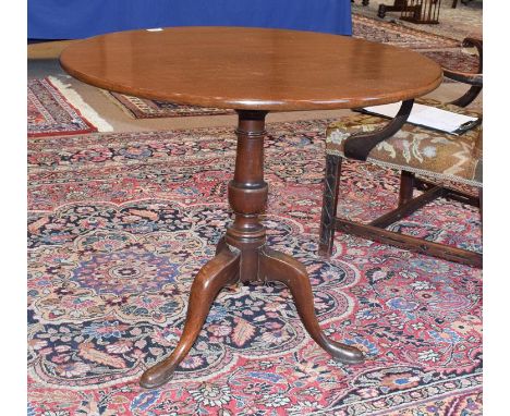 A George III Mahogany Tripod Table, late 18th century, the circular one-piece top on a turned vasiform support with three cab