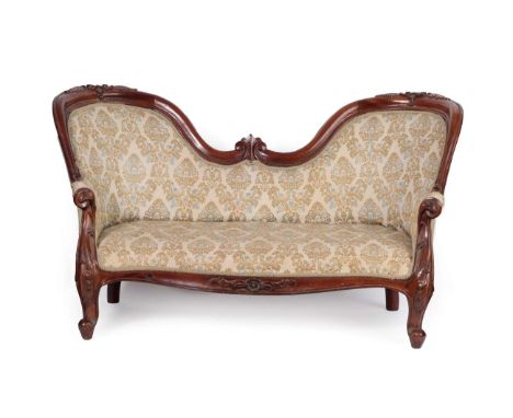 A Victorian Style Mahogany Child's Two-Seater Sofa, 20th century, upholstered in gold and blue floral fabric with a moulded c