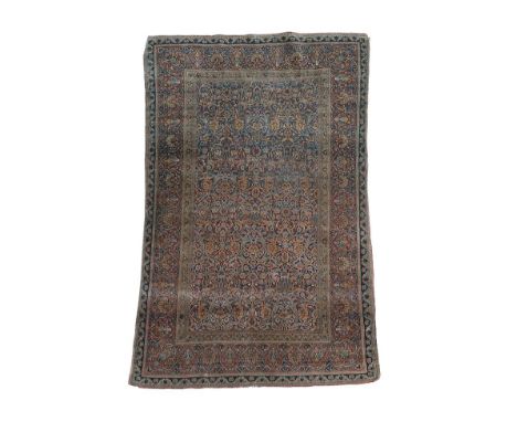 Kork Kashan Rug Central Iran, circa 1920 The deep indigo field of scrolling vines enclosed by madder borders of flower leaves