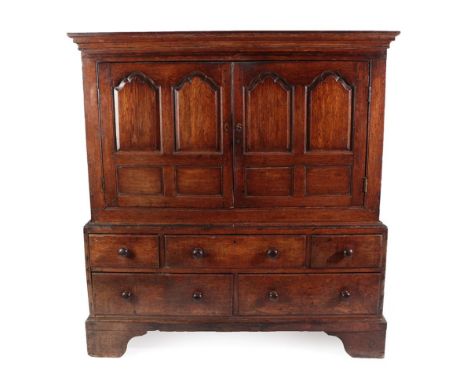 A Mid 18th Century Oak and Mahogany Crossbanded Livery Housekeeper's Cupboard, the moulded cornice above two cupboard doors w