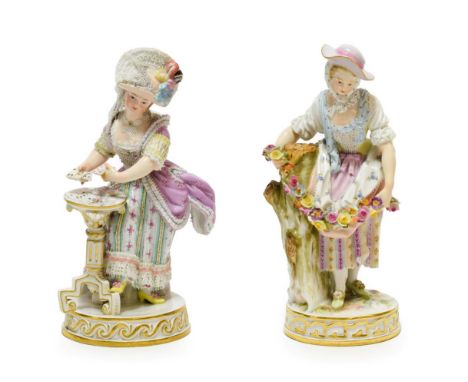 A Meissen Porcelain Figure of a Lady, circa 1900, standing wearing a lace-trimmed hat and dress dealing cards onto a tripod t