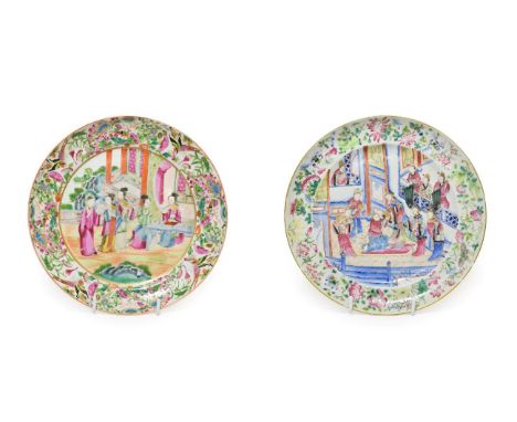 A Cantonese Porcelain Plate, circa 1830, painted in famille rose enamels with courtly figures in an interior within a foliate