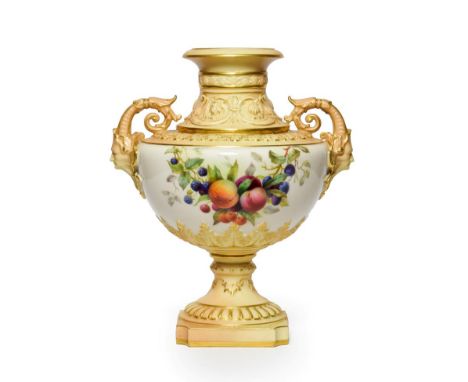 A Royal Worcester Porcelain Vase, 1904, of urn form with mask and scroll handles, painted with a swag and a bunch of fruit wi