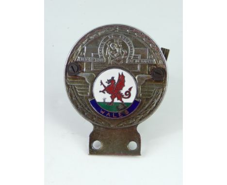 A Wales cast metal and enamel car badge, 'Behold St Christopher, Then Go Your Way In Safety'.