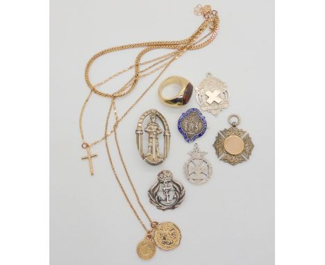 Three silver fob medallions, a silver and enamel nursing brooch, a Royal Navy Sweetheart brooch, a silver King Arthur brooch 