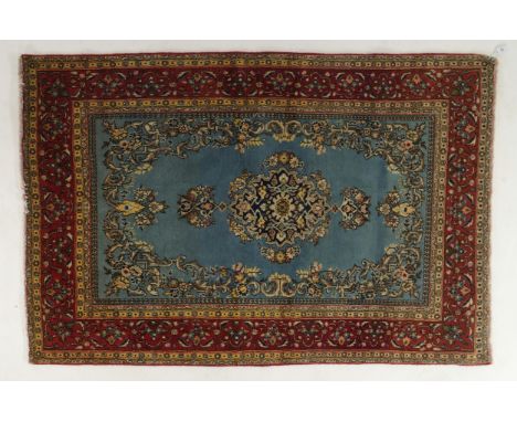 A light blue ground Qom rug with dark blue floral medallion, matching spandrels and red flower head border, 155cm long x 99cm
