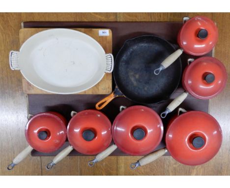 A lot of six Le Crueset cast iron enamel saucepans with lids, ashet, Cousances skillet and a butcher block cutting board (9) 